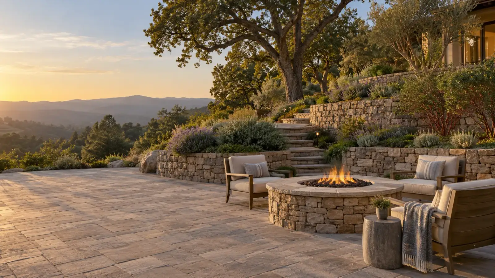 Terraced stone retaining walls and paver patio with a fire pit in the Saratoga foothills