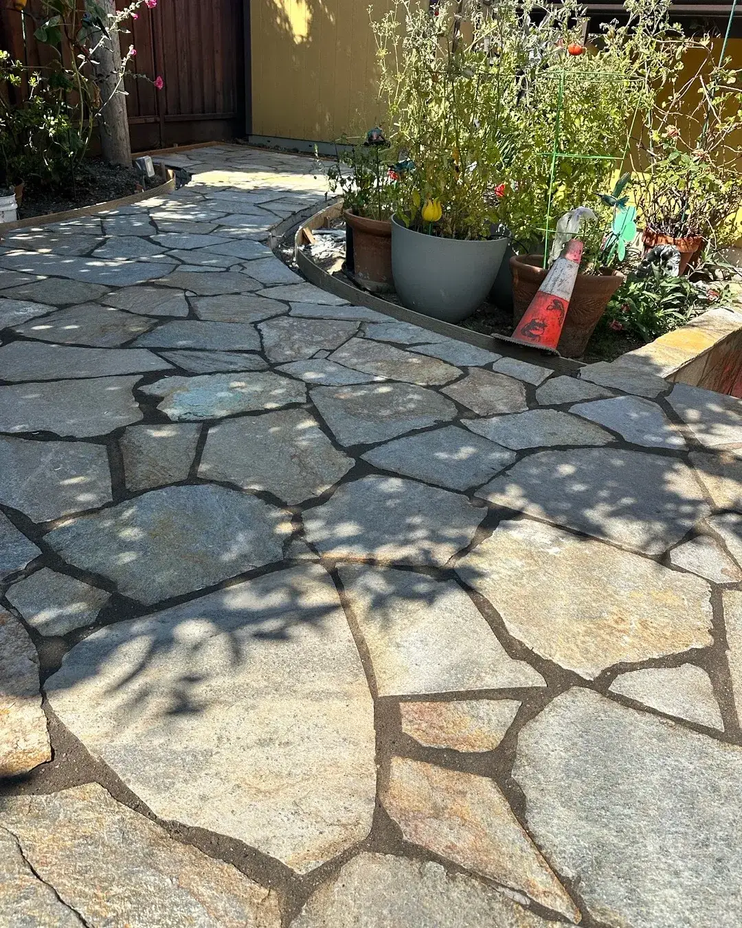 Flagstone path beside raised planter beds
