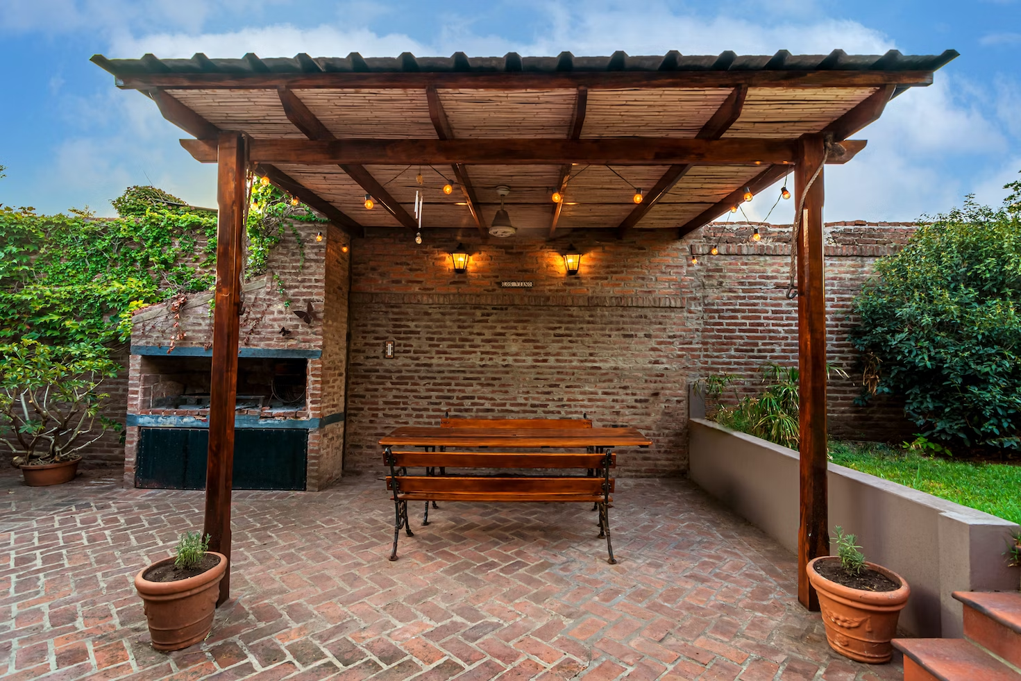 A retaining wall to create a cozy pergola and patio area