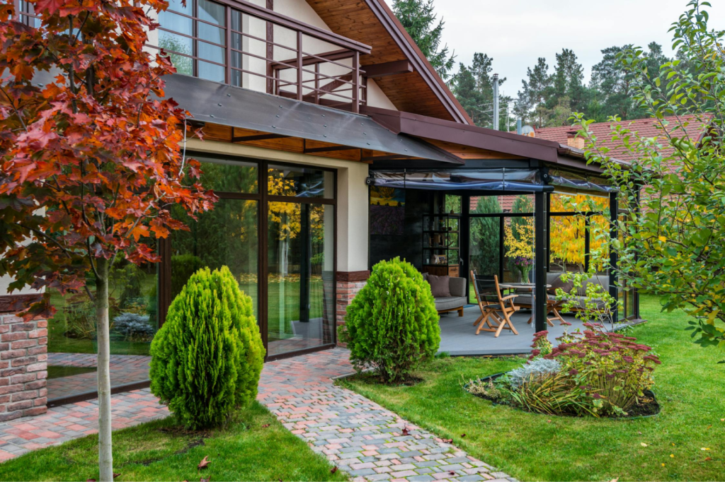 A concrete patio and pavers laid out outside a home.